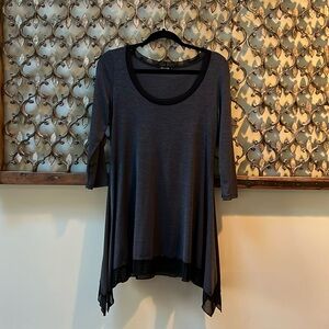 Black tunic/blouse. Sheer edges at neck & hem.